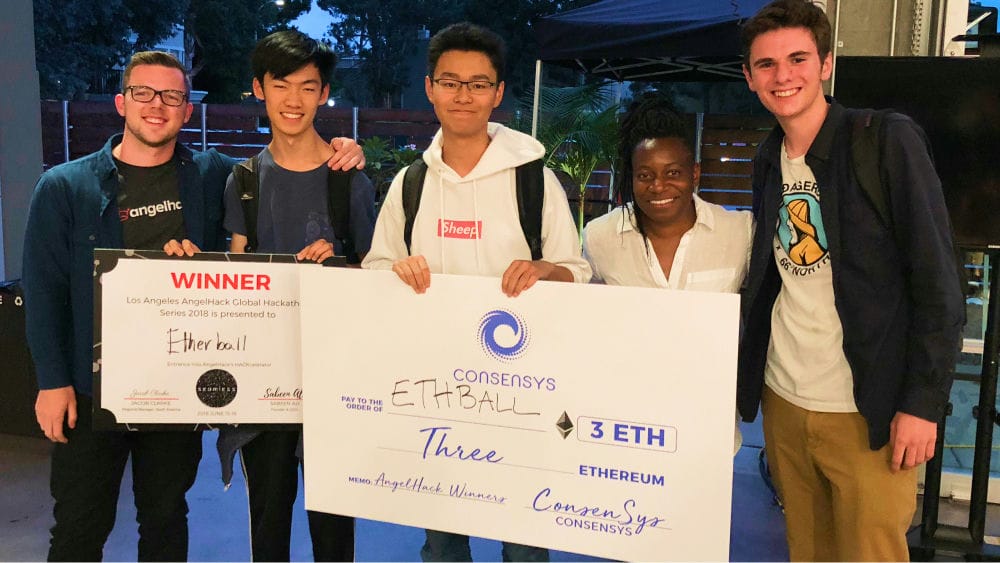 Winning team at the AngelHack LA, sponsored by Consensys, celebrates their innovative Ethereum blockchain solution, showcasing talent and collaboration in technology."