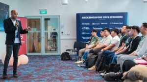 A person delivering a speech to an attentive audience at a public event.