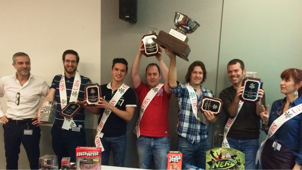 People lifting awards and smiling looking at the camera post the event.